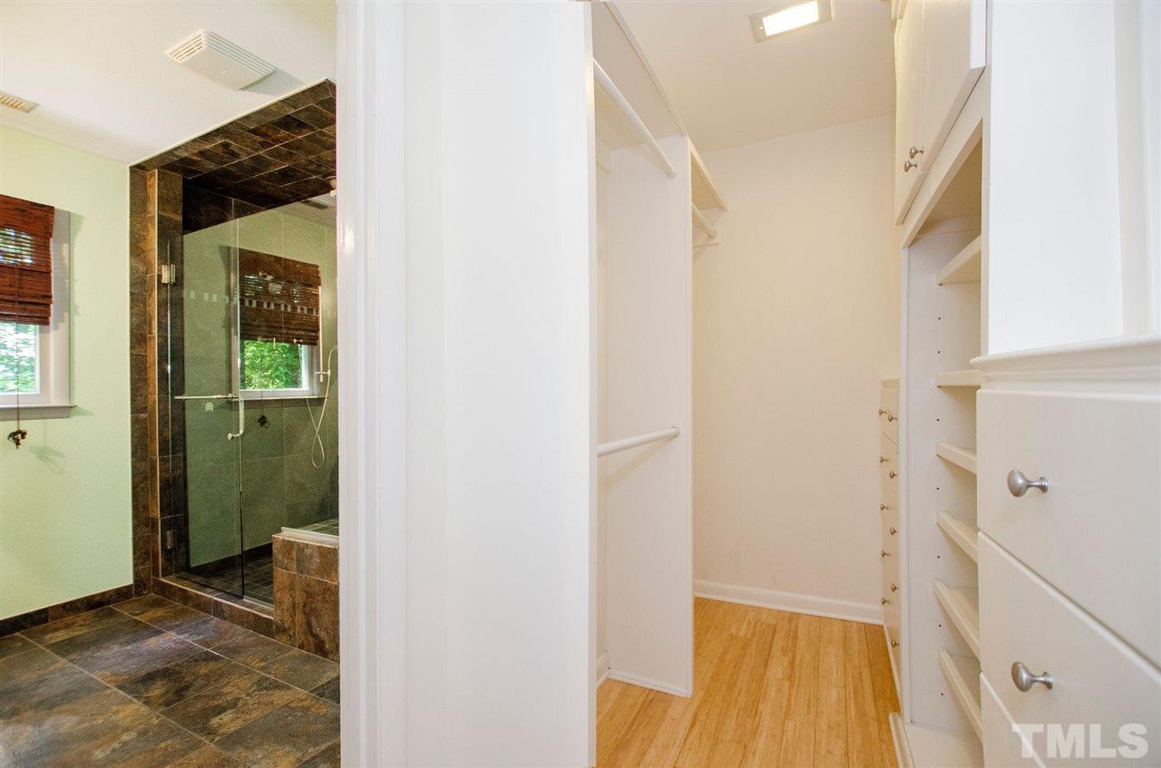 6205 Lookout Loop Raleigh, NC 27612 - Photo 12 of 25 a view of a hallway with wooden floor and a bathroom