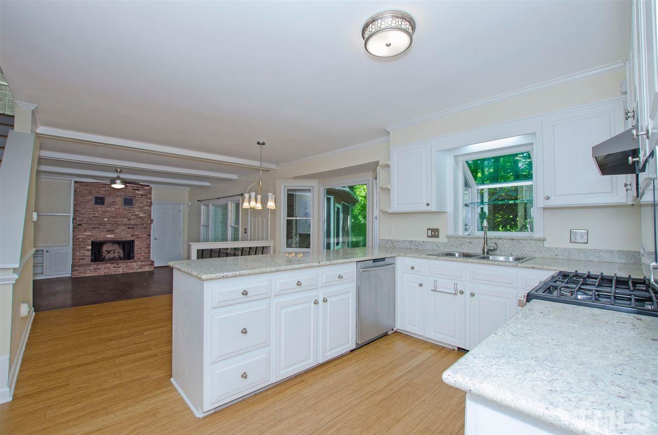 6205 Lookout Loop Raleigh, NC 27612 - Photo 6 of 25 a kitchen with a sink stove and cabinets