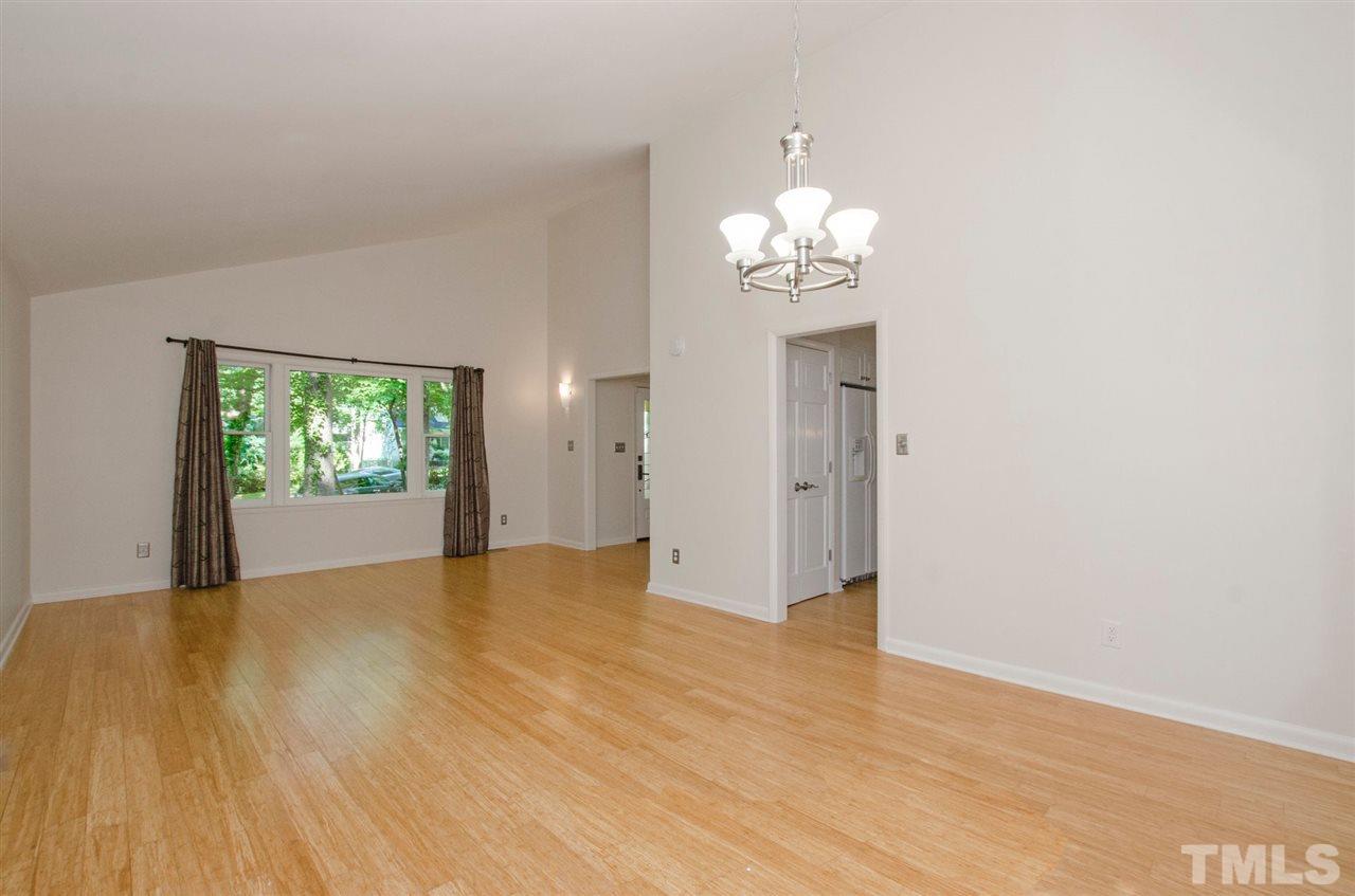 6205 Lookout Loop Raleigh, NC 27612 - Photo 10 of 25 a view of an empty room with wooden floor and a window