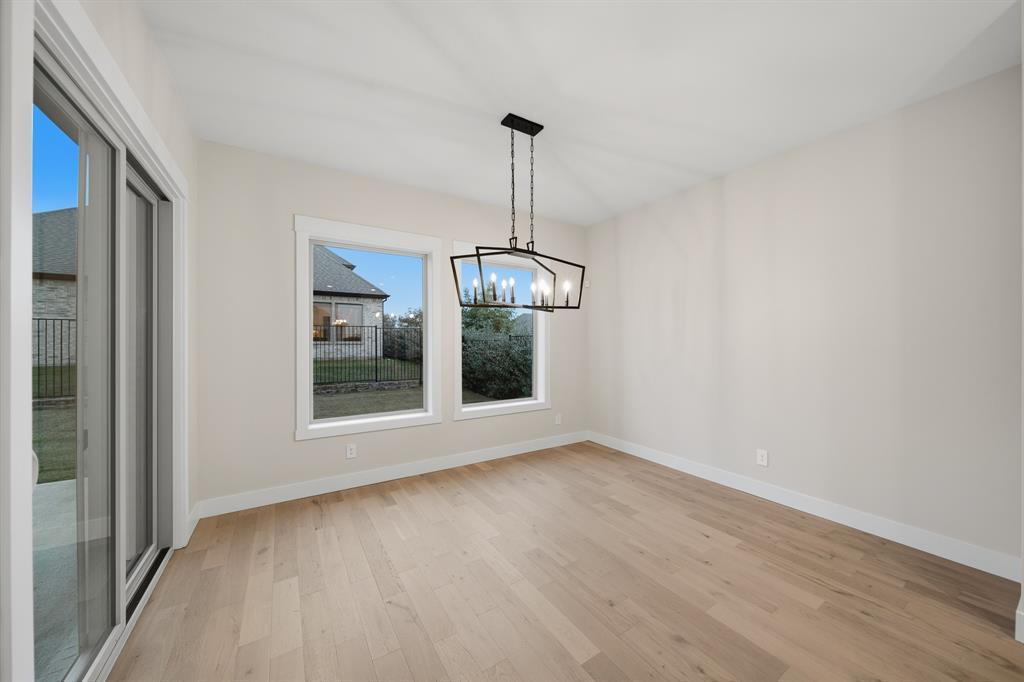 1902 Pebble Lane Rockwall, TX 75087 - Photo 14 of 35 a view of an empty room with chandelier and window