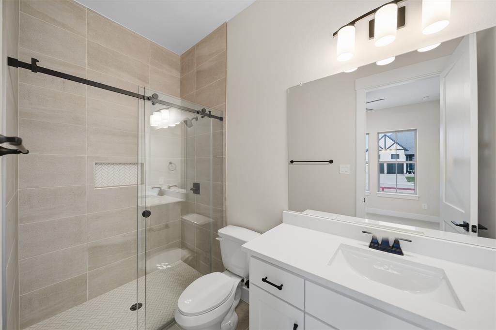 1902 Pebble Lane Rockwall, TX 75087 - Photo 24 of 35 a bathroom with a sink a toilet and shower