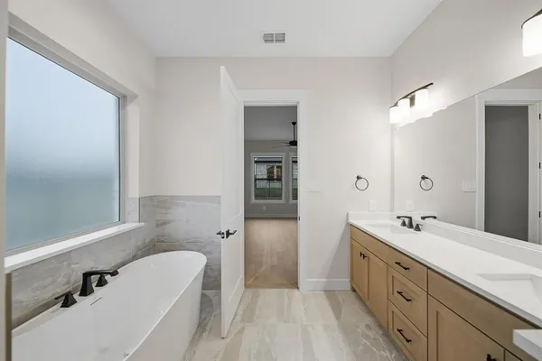 a bathroom with a sink vanity mirror and toilet
