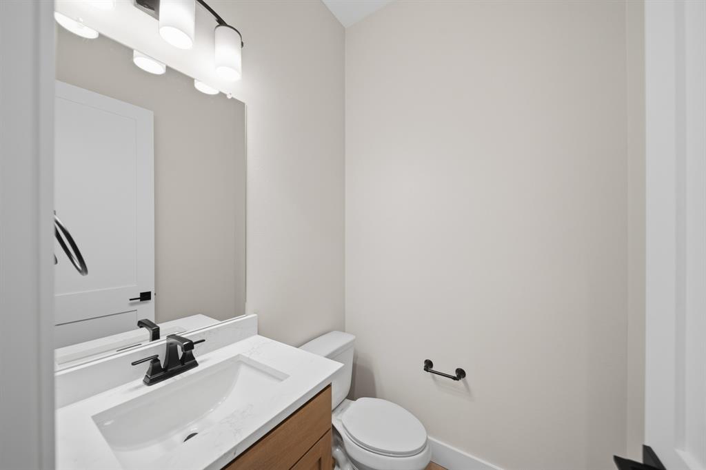 1902 Pebble Lane Rockwall, TX 75087 - Photo 26 of 35 a bathroom with a sink vanity mirror and toilet