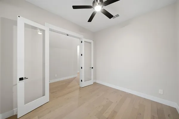 a view of a room with a ceiling fan