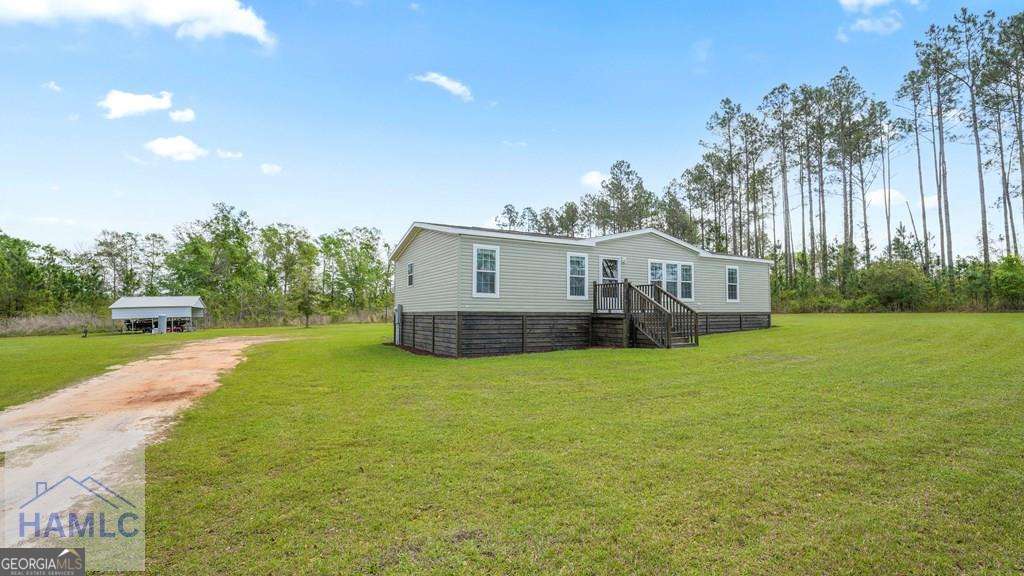 876 Hires Road Jesup, GA 31545 - Photo 30 of 30 a house view with a garden space