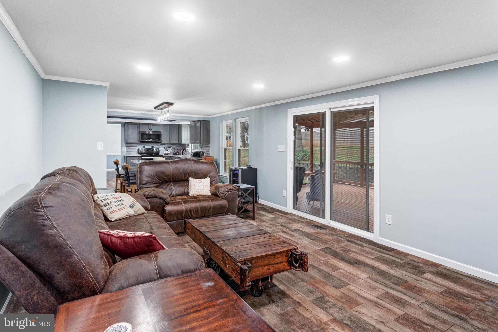 4586 Rincon Place Dumfries, VA 22025 - Photo 16 of 46 a living room with furniture and a wooden floor