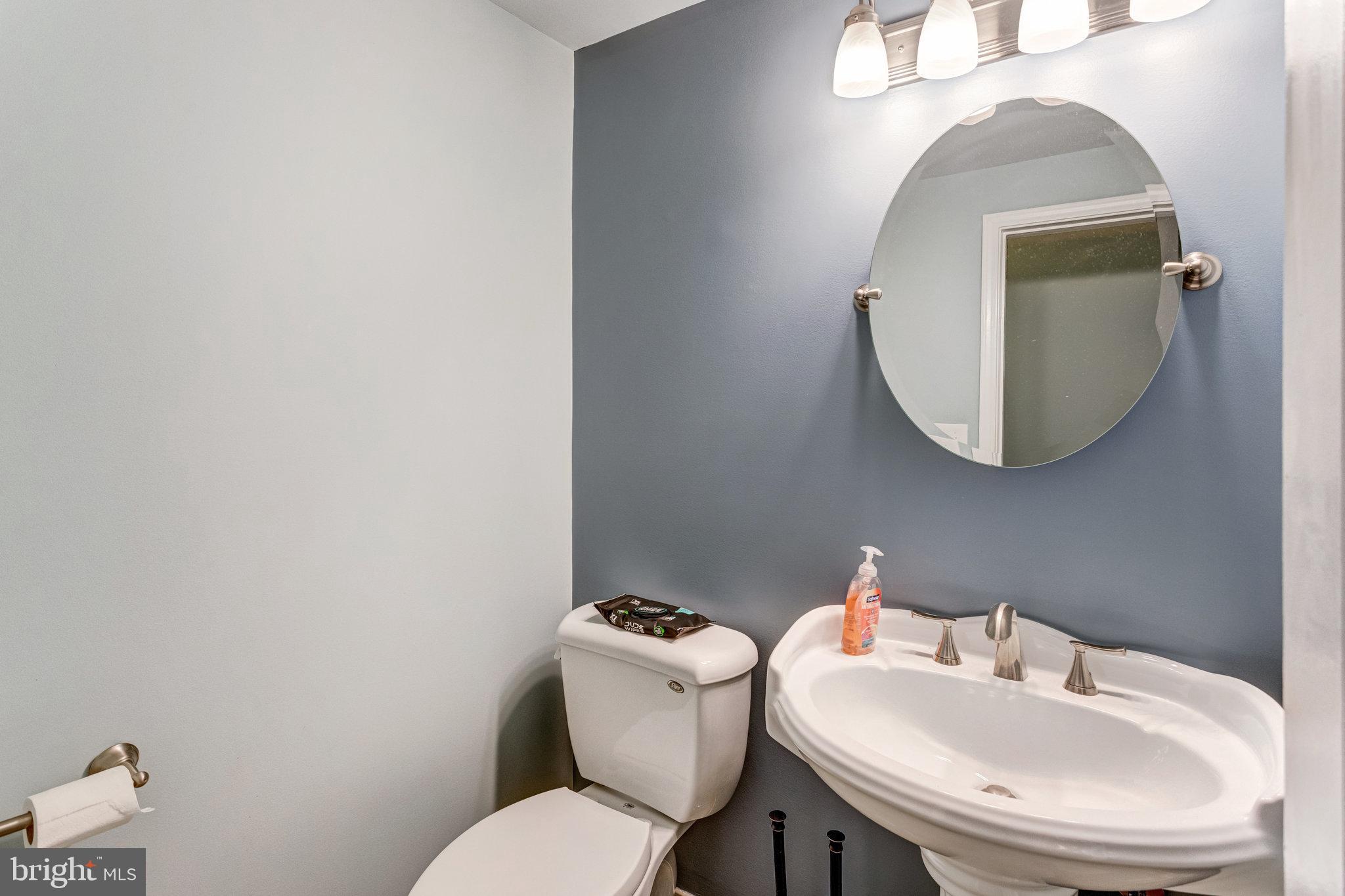 4586 Rincon Place Dumfries, VA 22025 - Photo 17 of 46 a bathroom with a toilet sink and mirror