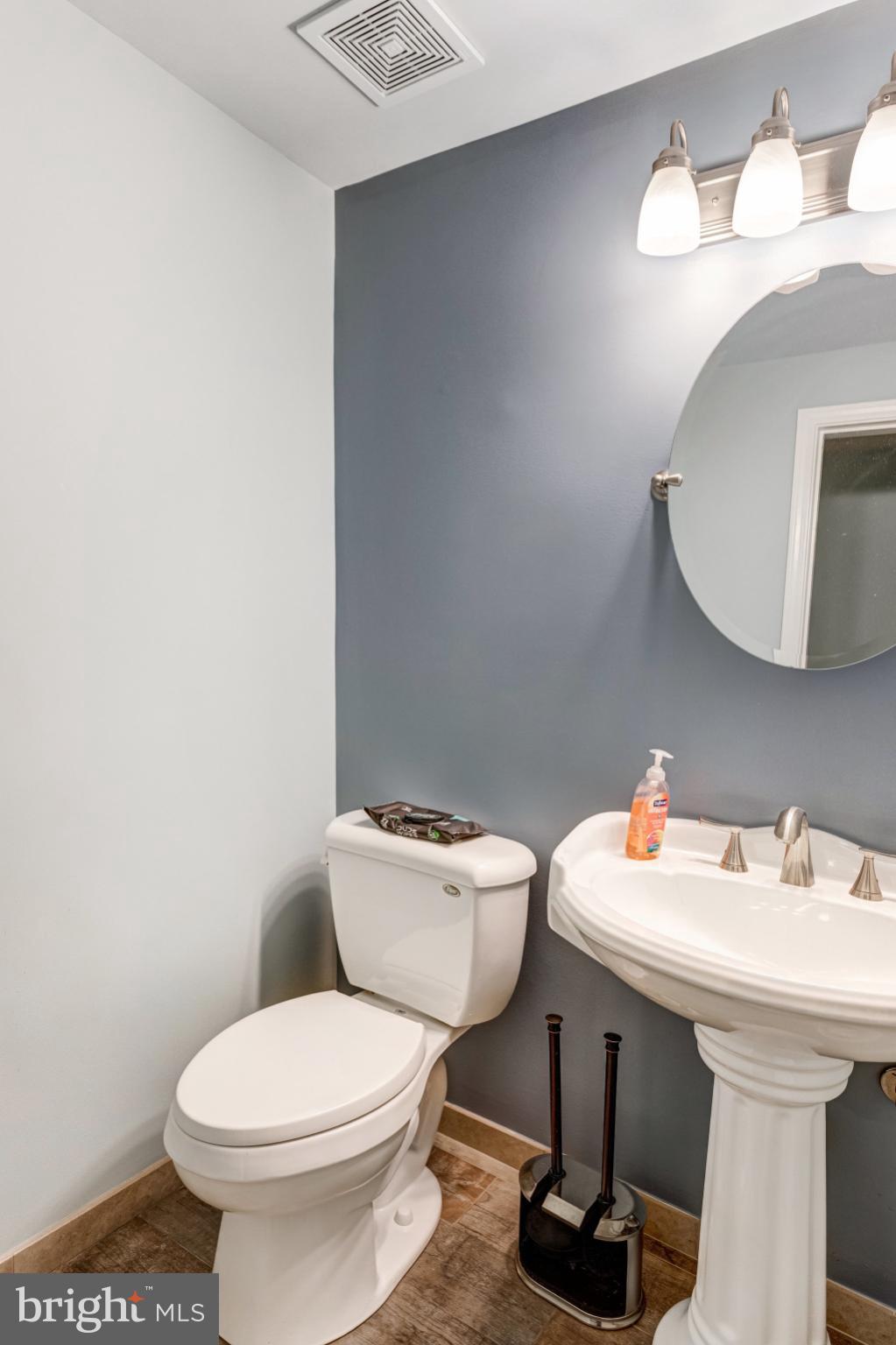 4586 Rincon Place Dumfries, VA 22025 - Photo 18 of 46 a bathroom with a toilet a sink and mirror
