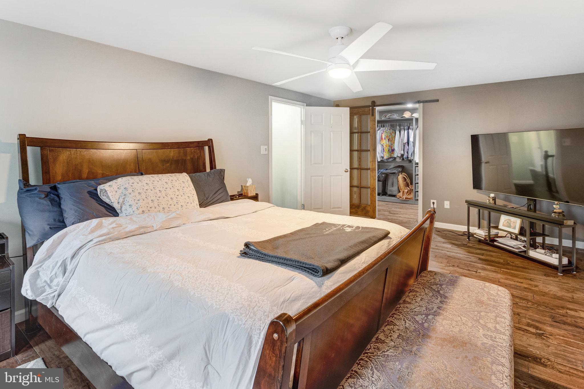 4586 Rincon Place Dumfries, VA 22025 - Photo 21 of 46 a spacious bedroom with a bed and a flat screen television