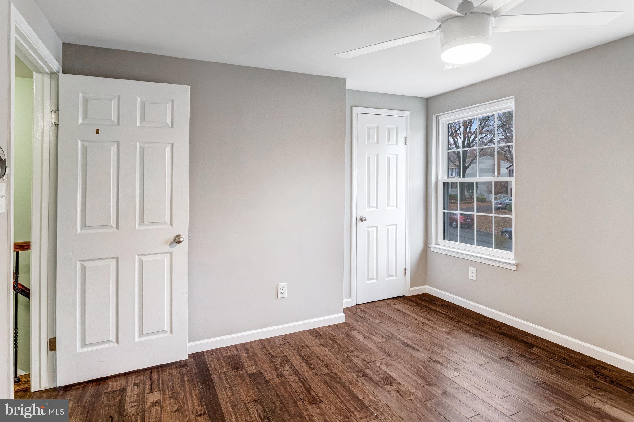 4586 Rincon Place Dumfries, VA 22025 - Photo 27 of 46 a view of an empty room with window and wooden floor