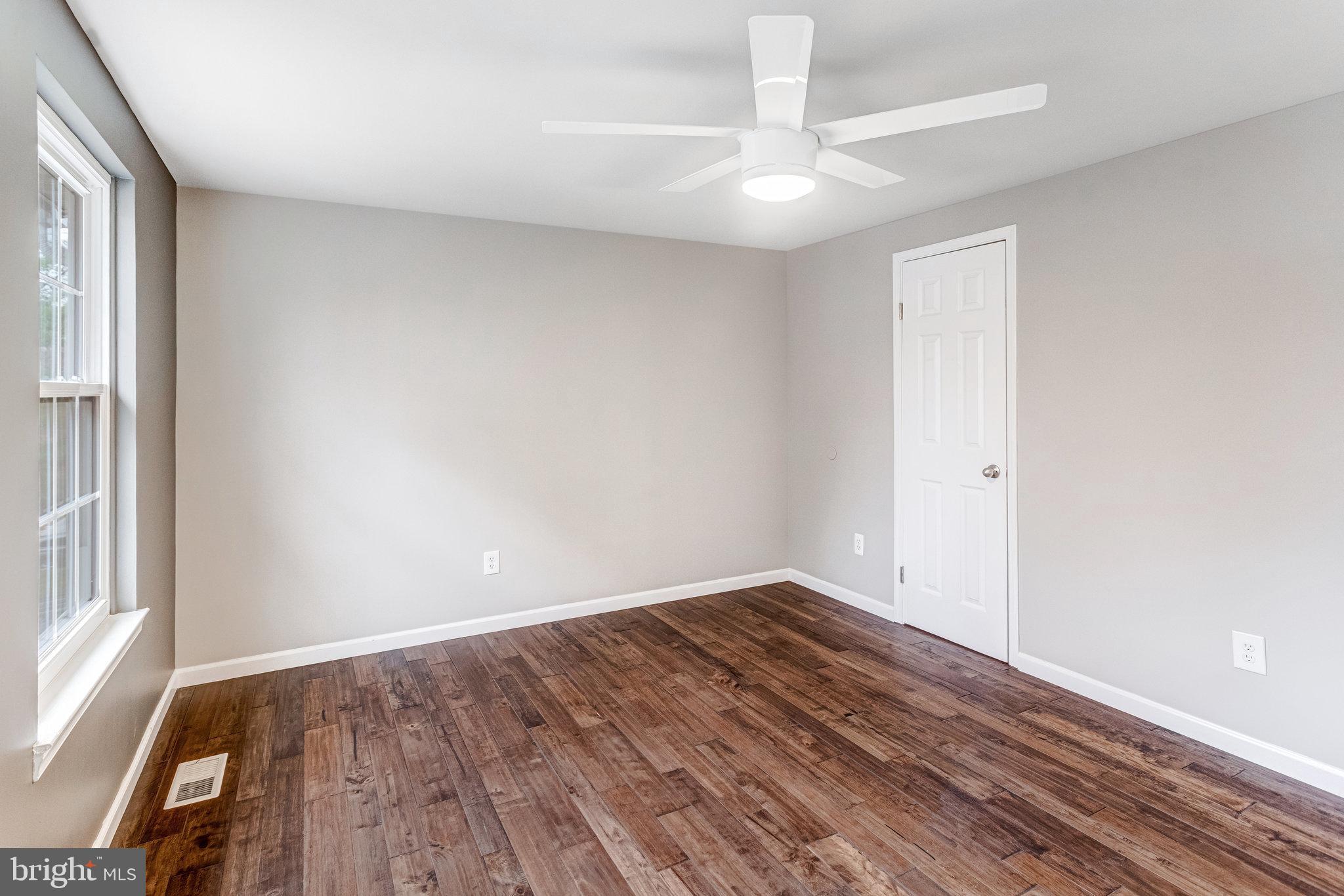 4586 Rincon Place Dumfries, VA 22025 - Photo 30 of 46 an empty room with wooden floor and windows