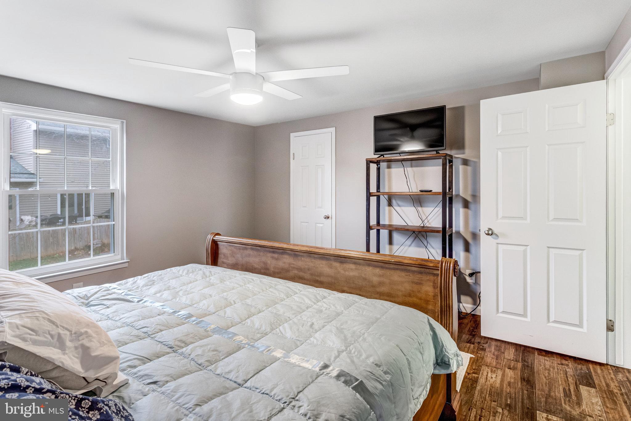 4586 Rincon Place Dumfries, VA 22025 - Photo 31 of 46 a bedroom with a bed cabinets and a window