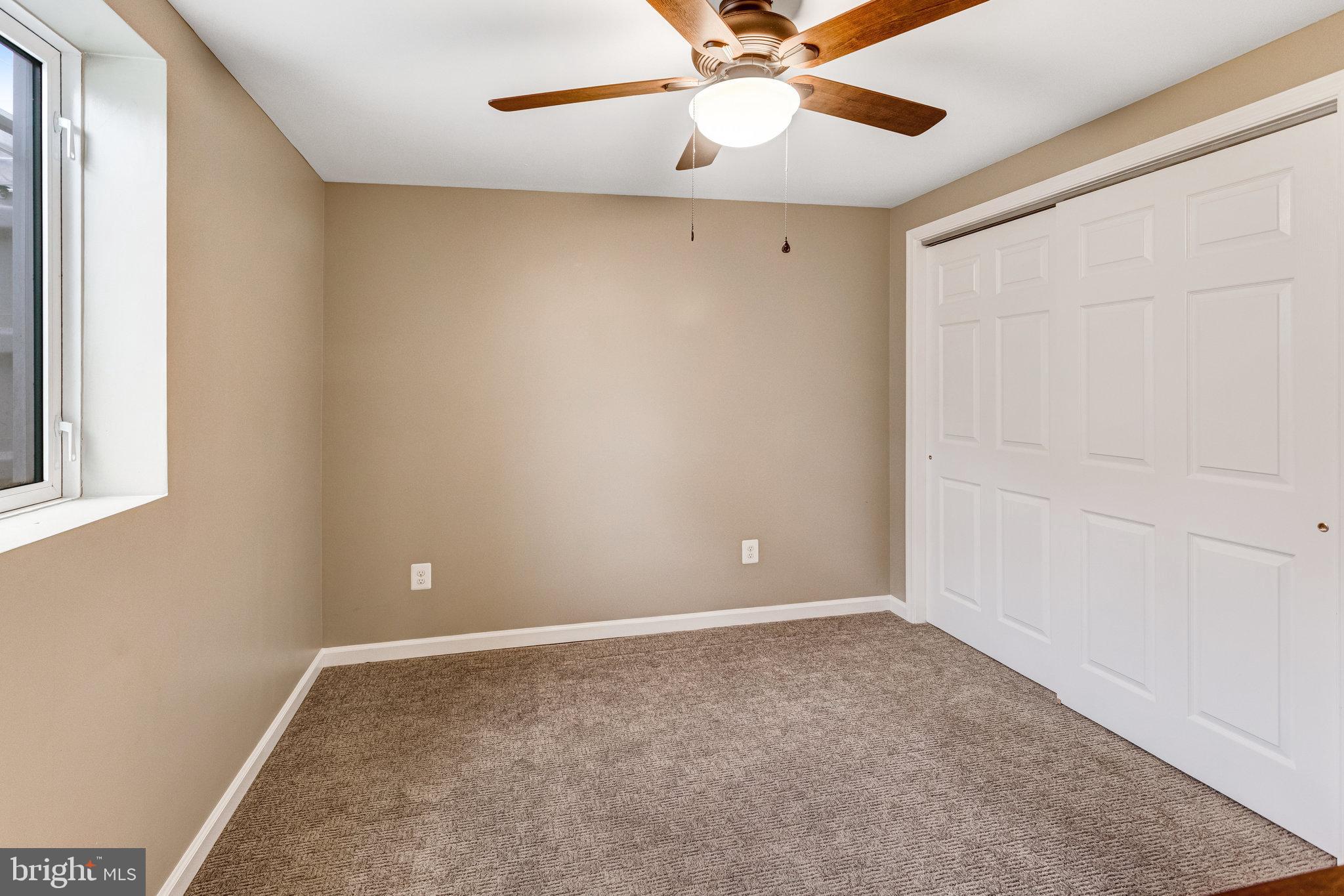 4586 Rincon Place Dumfries, VA 22025 - Photo 35 of 46 an empty room with a window and a fan