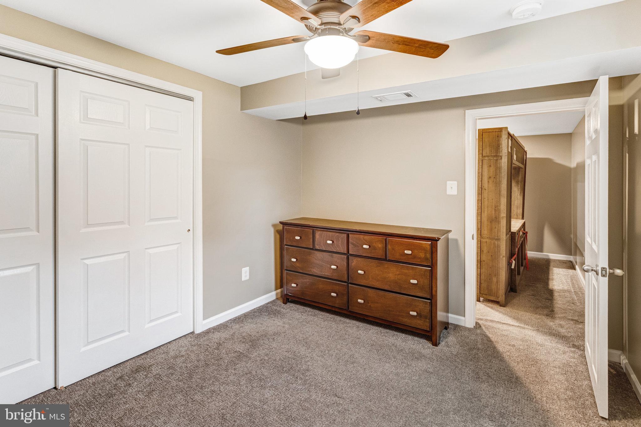 4586 Rincon Place Dumfries, VA 22025 - Photo 36 of 46 a room with a baby crib and a dresser
