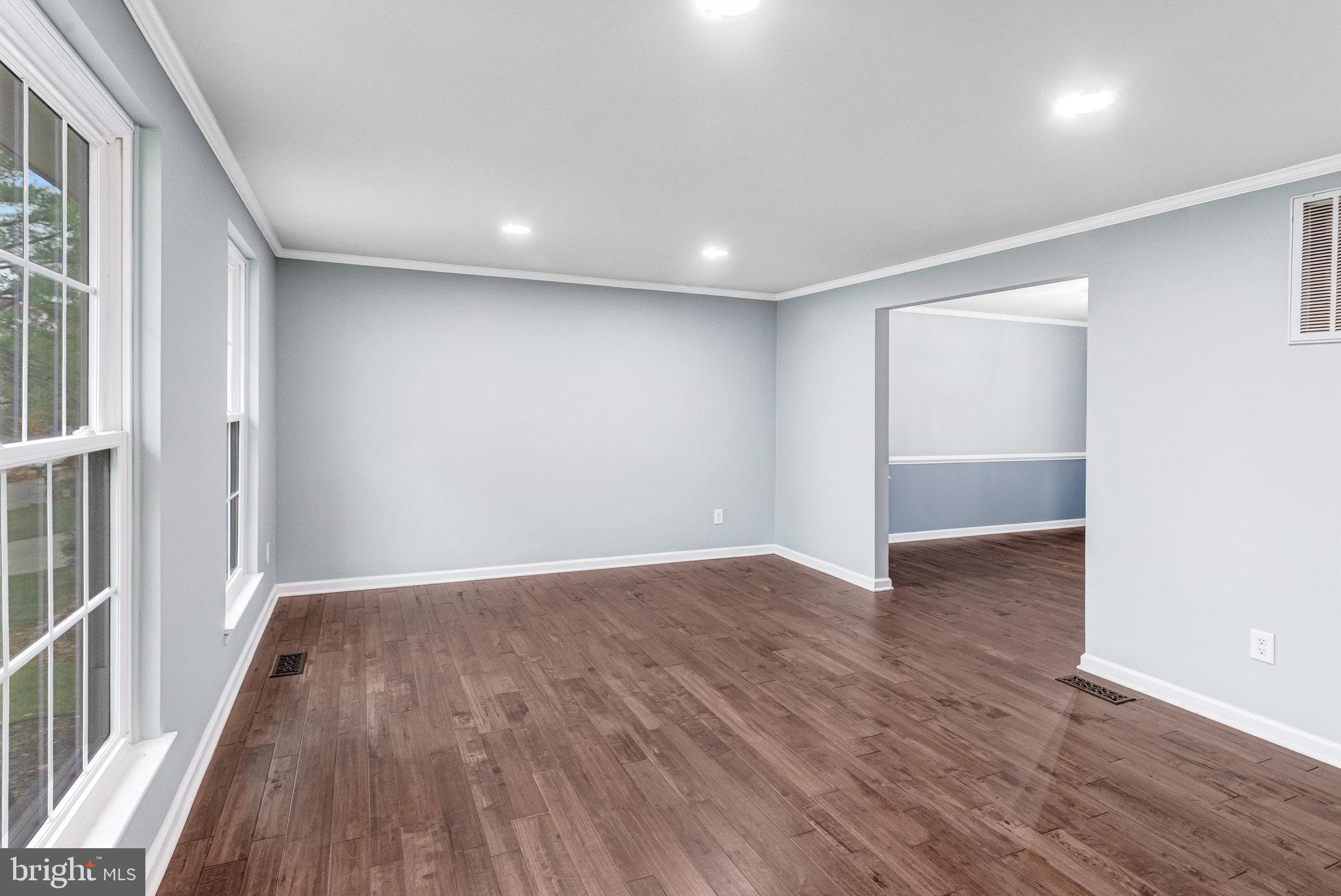 4586 Rincon Place Dumfries, VA 22025 - Photo 5 of 46 wooden floor in an empty room with a window