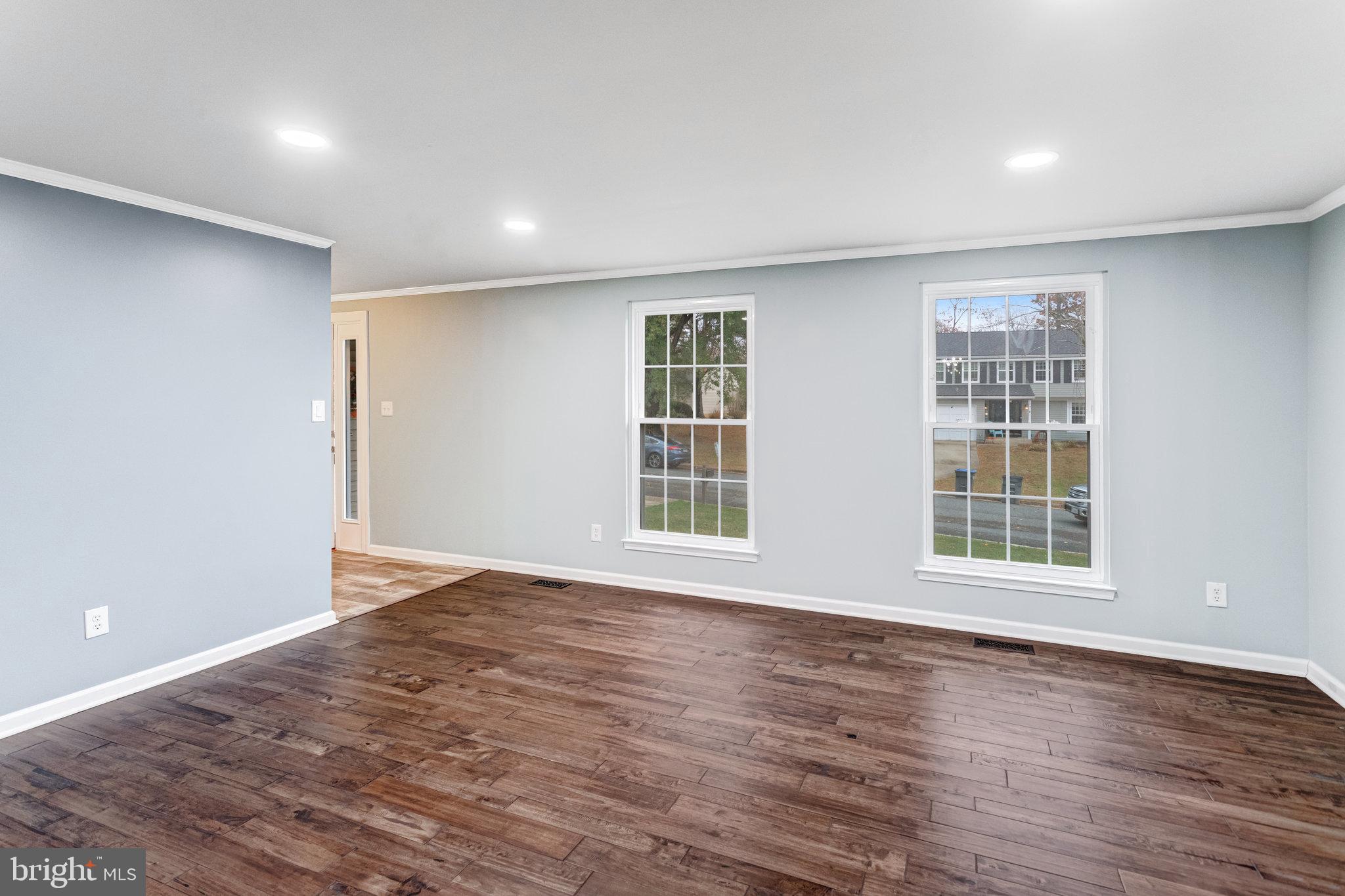 4586 Rincon Place Dumfries, VA 22025 - Photo 7 of 46 a view of an empty room with wooden floor and windows