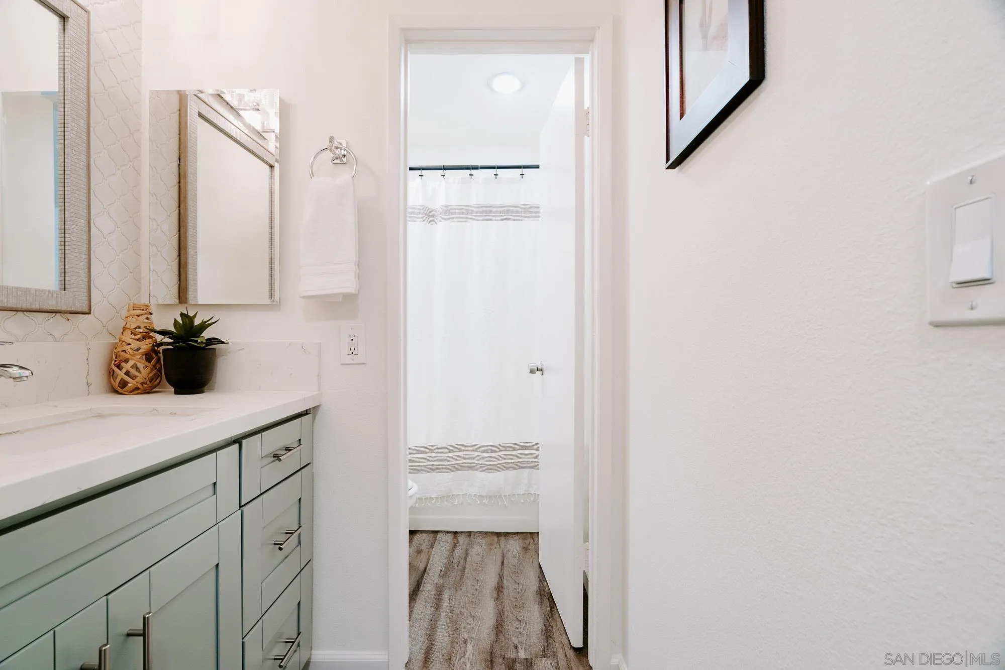 6780 Friars Road, Unit 346 San Diego, CA 92108 - Photo 18 of 29 a bathroom with a sink a mirror and a shower