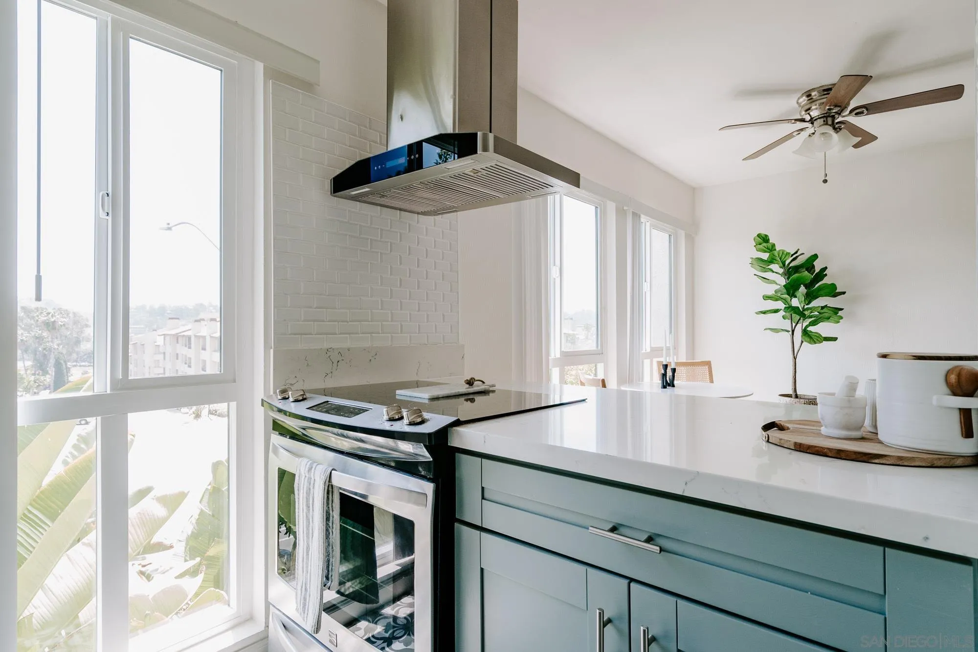 6780 Friars Road, Unit 346 San Diego, CA 92108 - Photo 7 of 29 a kitchen with stainless steel appliances a sink a window and a potted plant