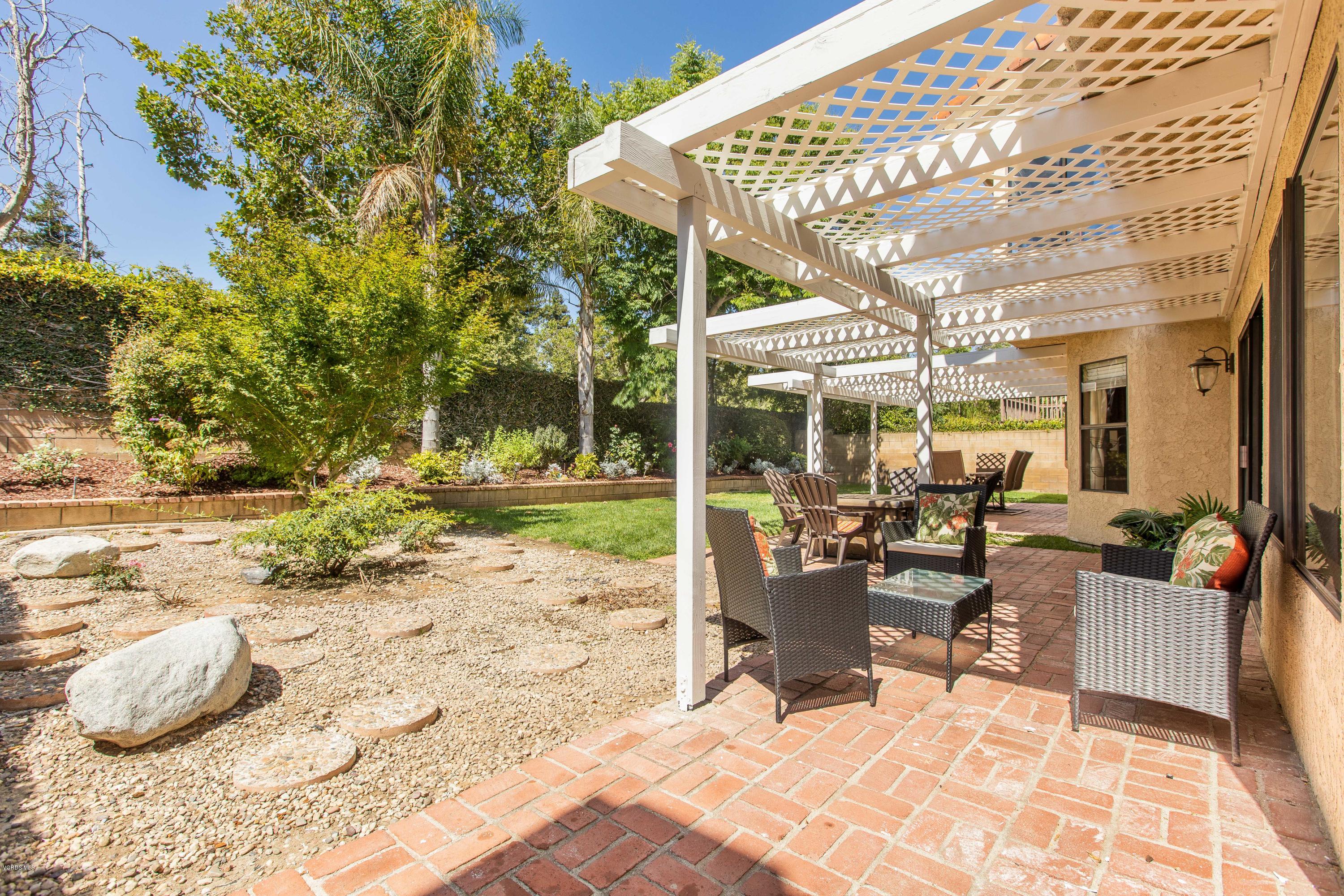 4034 Doneva Road Moorpark, CA 93021 - Photo 15 of 47 a view of a patio with a table and chairs and potted plants