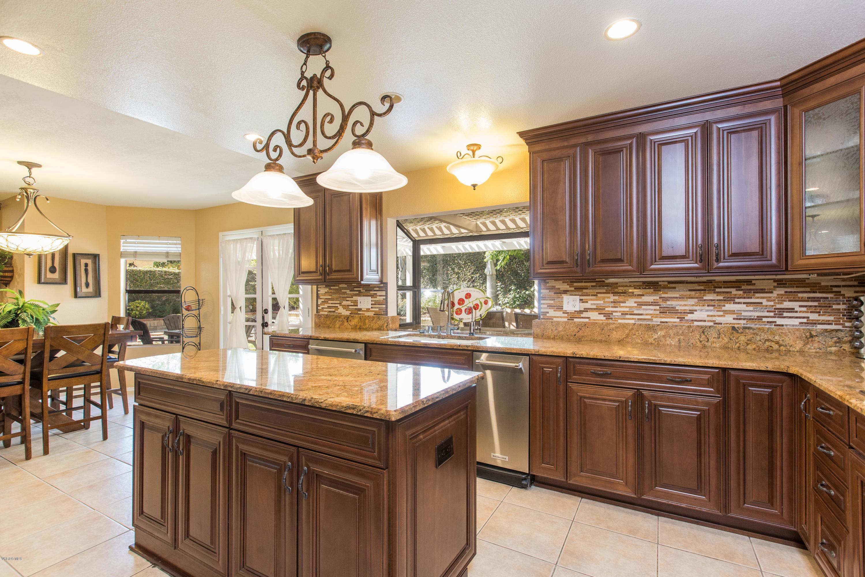 4034 Doneva Road Moorpark, CA 93021 - Photo 3 of 47 a kitchen with a sink stove and wooden cabinets
