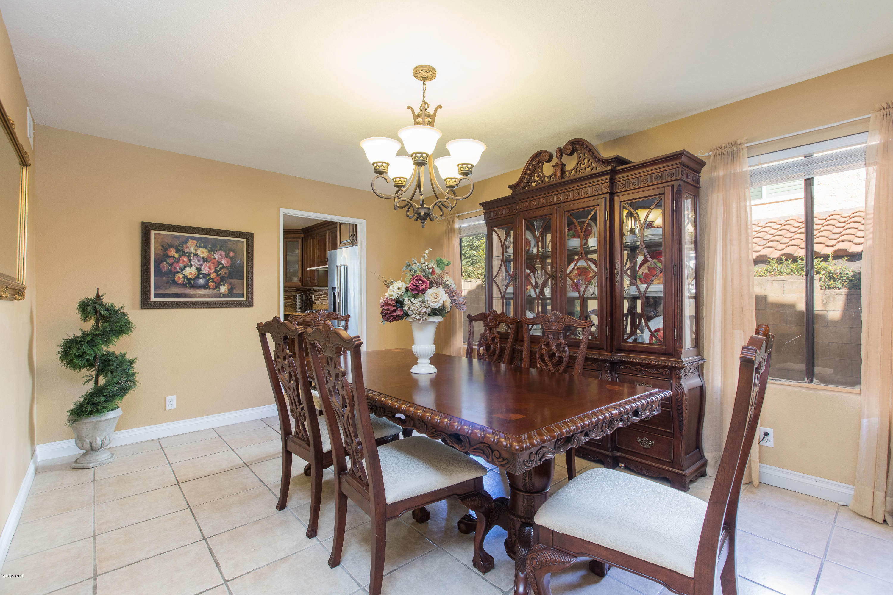 4034 Doneva Road Moorpark, CA 93021 - Photo 24 of 47 a dining room with wooden floor a chandelier a wooden table and chairs
