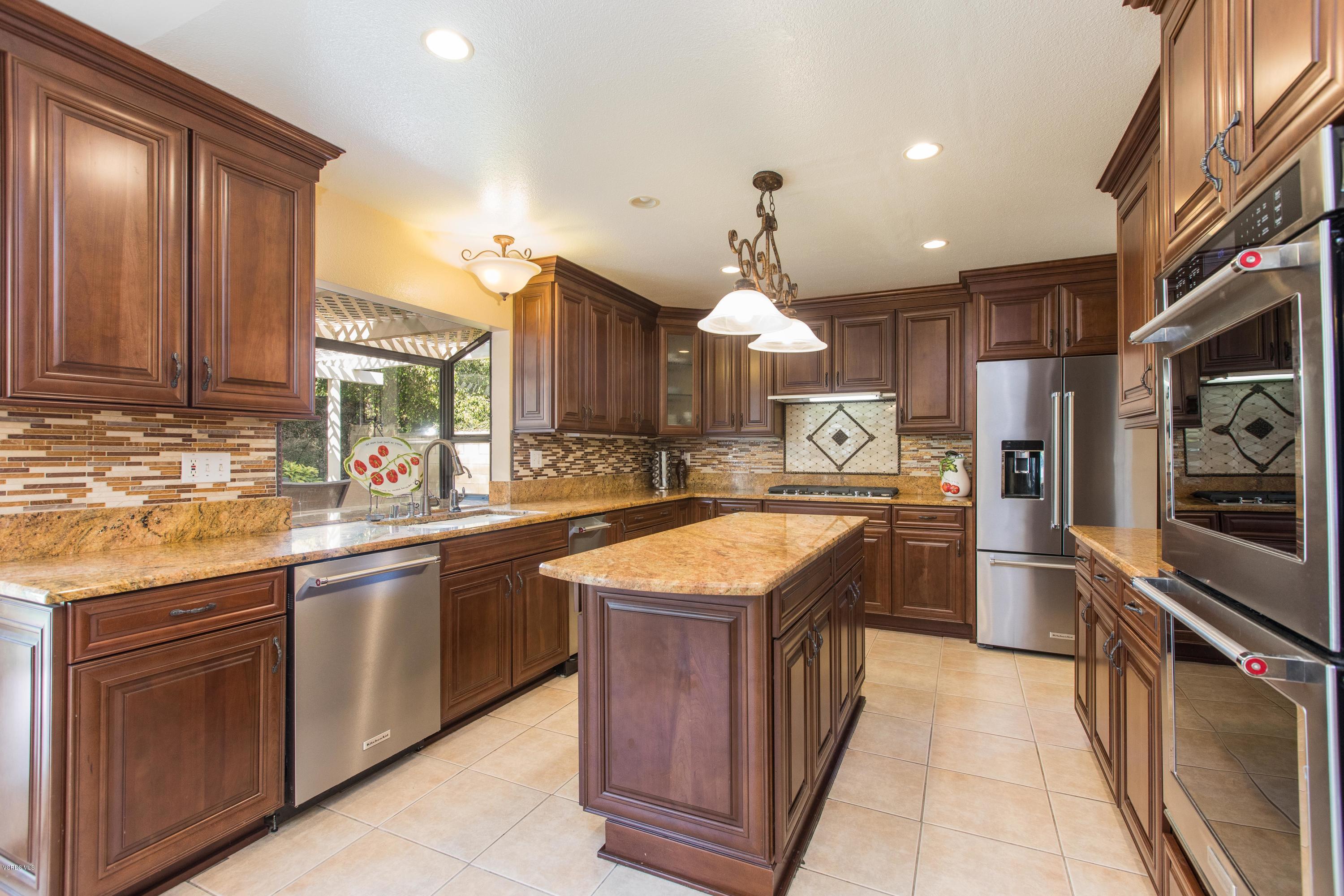 4034 Doneva Road Moorpark, CA 93021 - Photo 4 of 47 a kitchen with stainless steel appliances granite countertop wooden cabinets and a sink