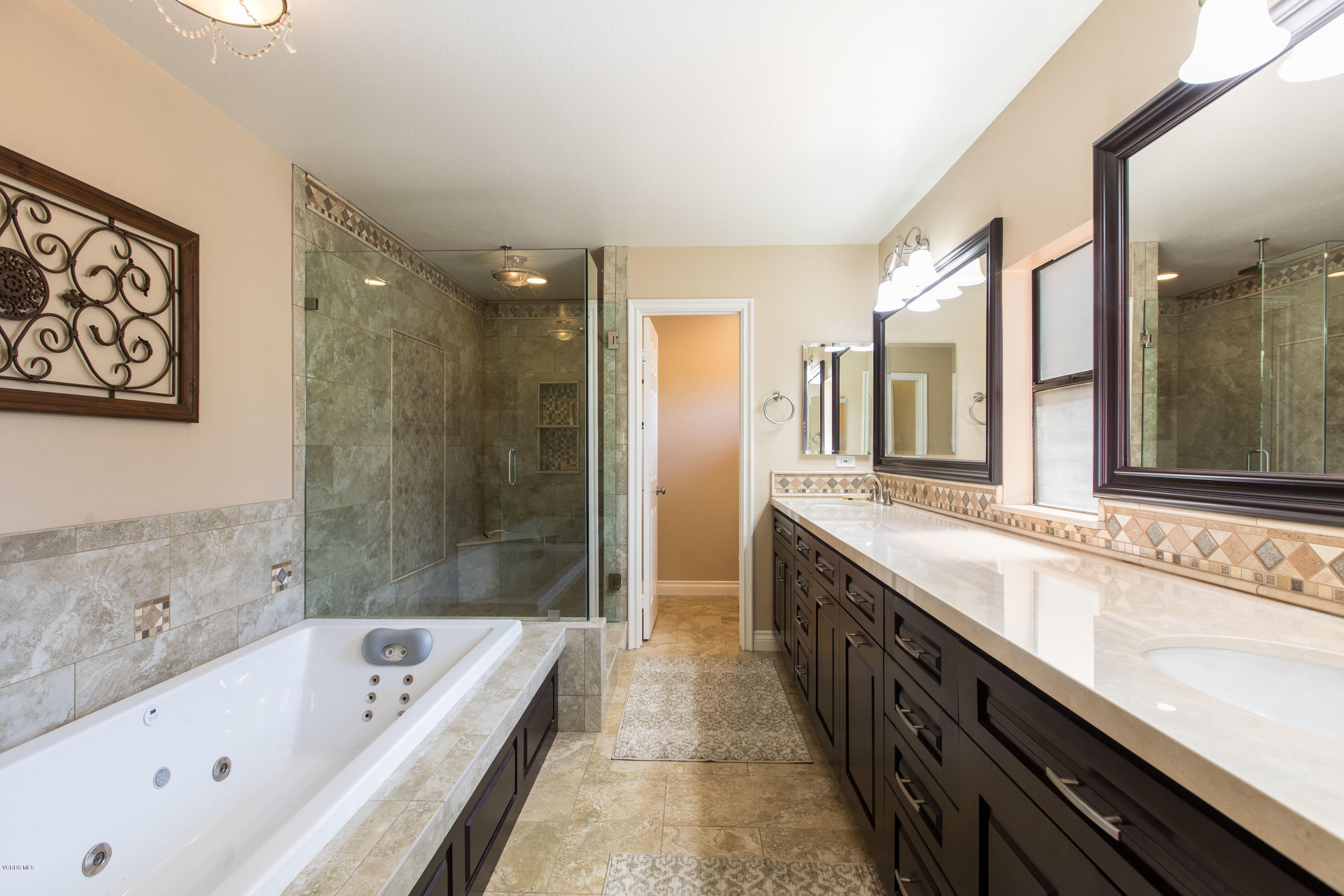 4034 Doneva Road Moorpark, CA 93021 - Photo 5 of 47 a bathroom with a granite countertop tub a double vanity sink and large mirror