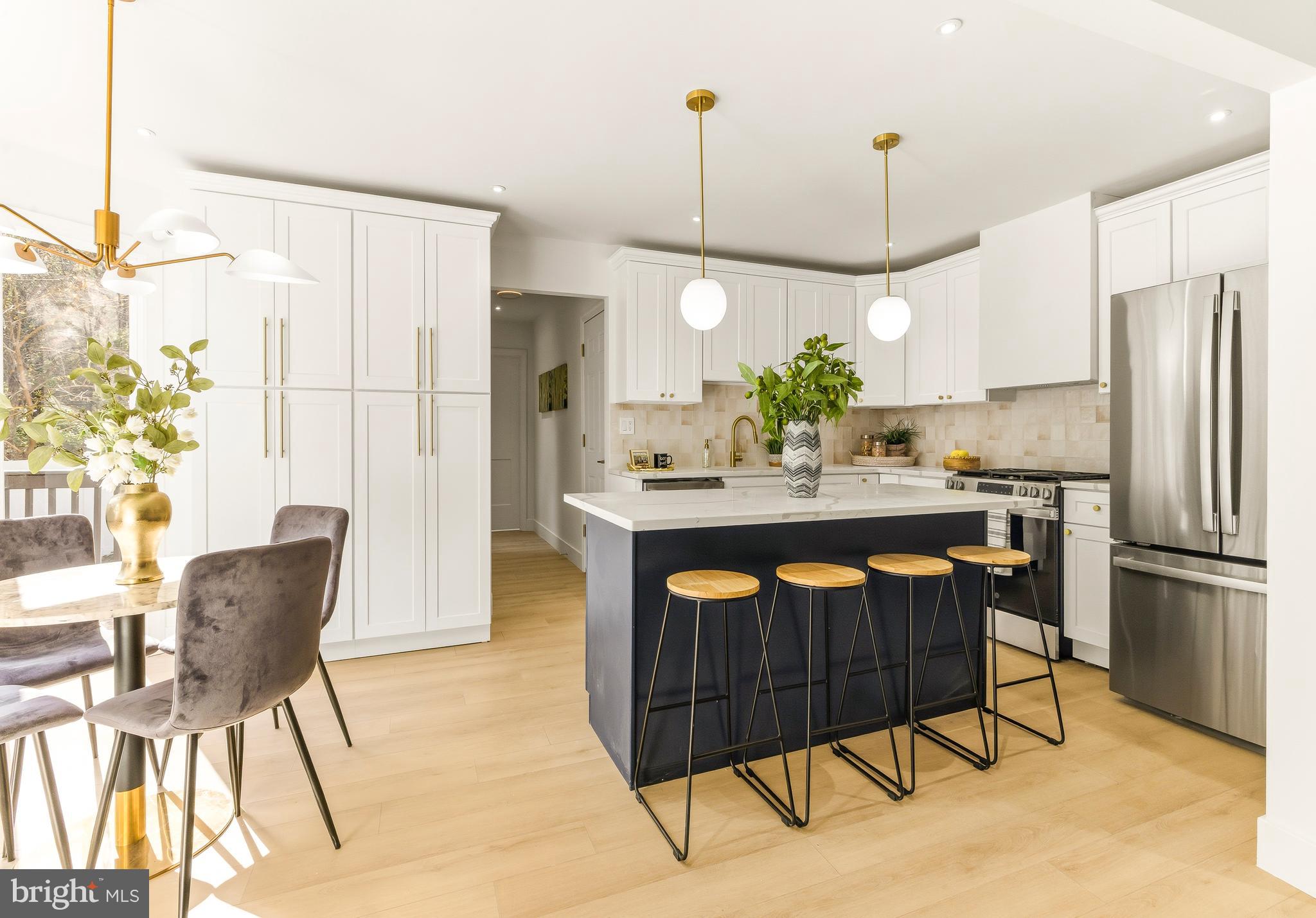2470 Medford Road Atco, NJ 08004 - Photo 9 of 22 a kitchen with stainless steel appliances granite countertop a refrigerator a sink dishwasher a dining table and chairs with wooden floor