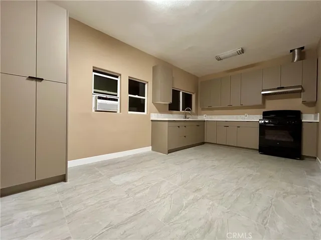 a kitchen with a stove and refrigerator