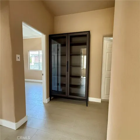 an empty room with window and mirror