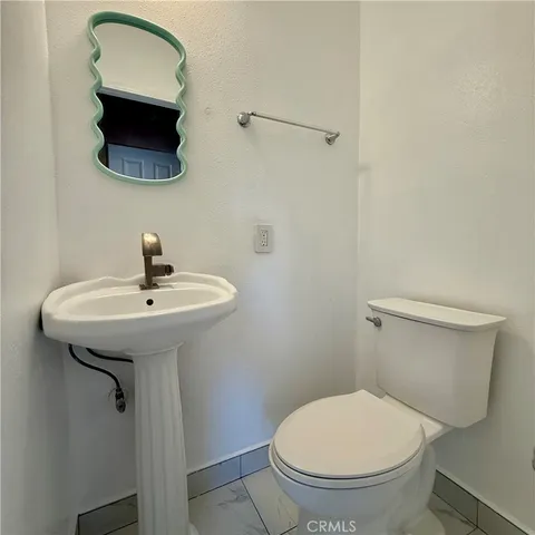 a bathroom with a toilet a sink and a mirror