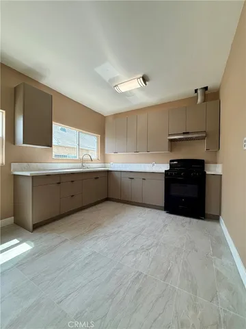 a kitchen with granite countertop a sink and cabinets