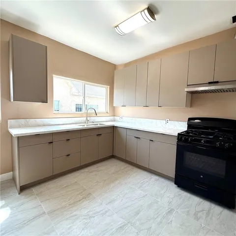 a kitchen with a sink stove and cabinets