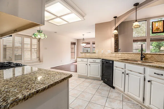 a kitchen with a sink stove and cabinets