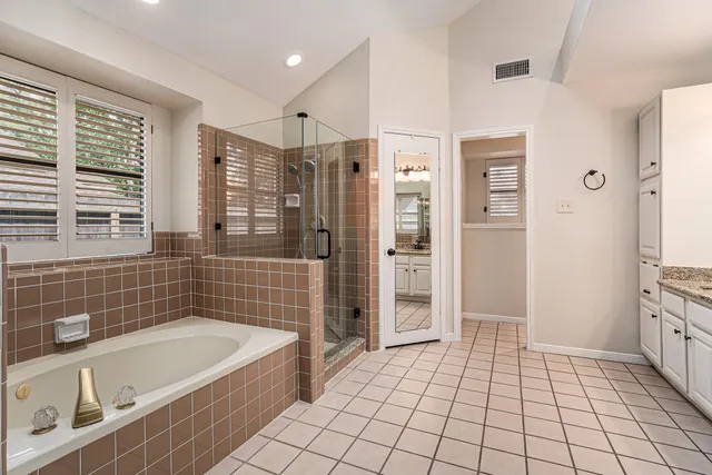 a bathroom with a bathtub and a shower