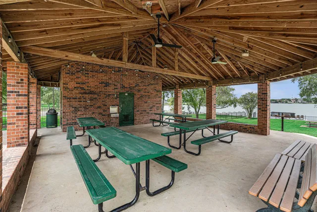 a view of a patio with a table and chairs under an umbrella