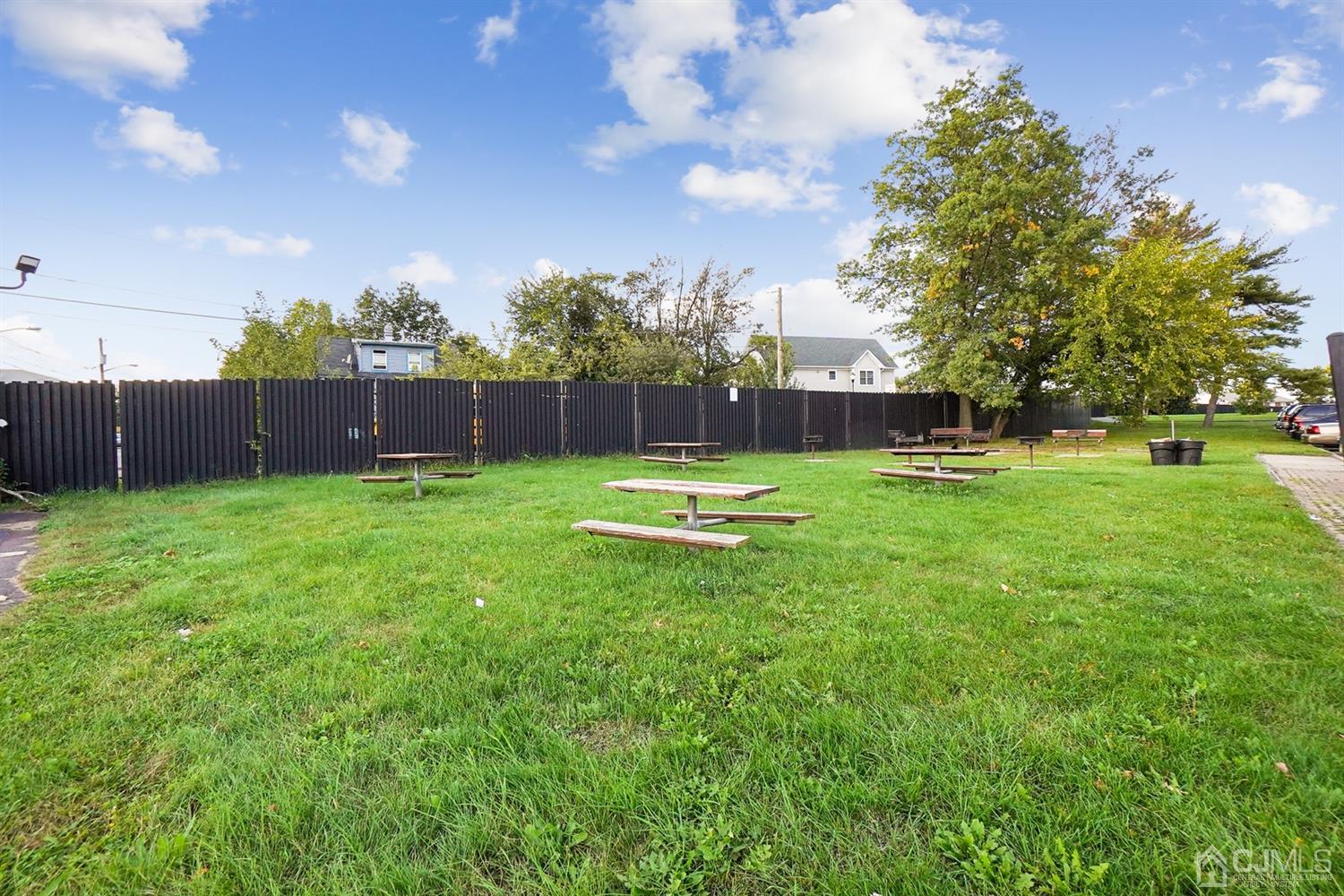 934 Edpas Road New Brunswick, NJ 08901 - Photo 16 of 16 a swimming pool with lots of green space and trees in the background