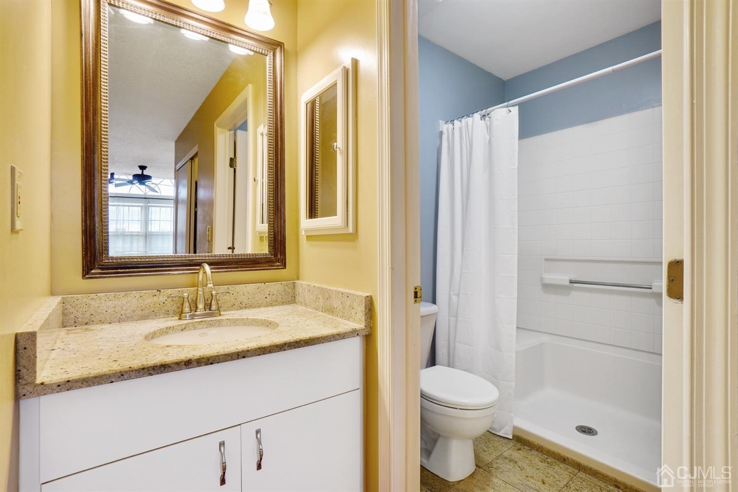 934 Edpas Road New Brunswick, NJ 08901 - Photo 5 of 16 a bathroom with a granite countertop sink toilet and shower