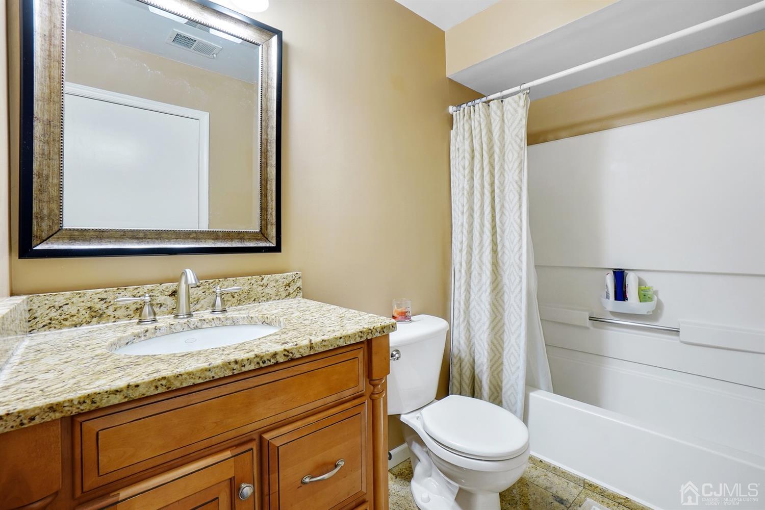 934 Edpas Road New Brunswick, NJ 08901 - Photo 6 of 16 a bathroom with a granite countertop toilet sink and mirror