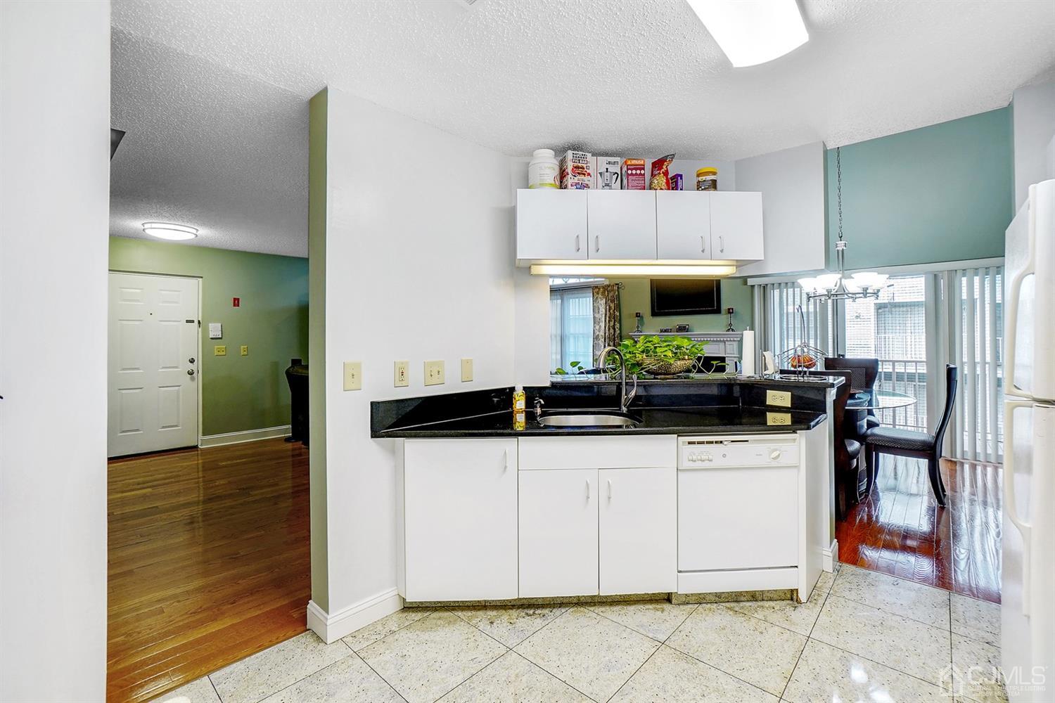 934 Edpas Road New Brunswick, NJ 08901 - Photo 8 of 16 a kitchen with stainless steel appliances a sink and a refrigerator