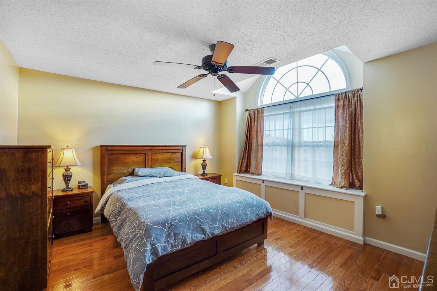 934 Edpas Road New Brunswick, NJ 08901 - Photo 9 of 16 a bedroom with a bed a chandelier and dresser
