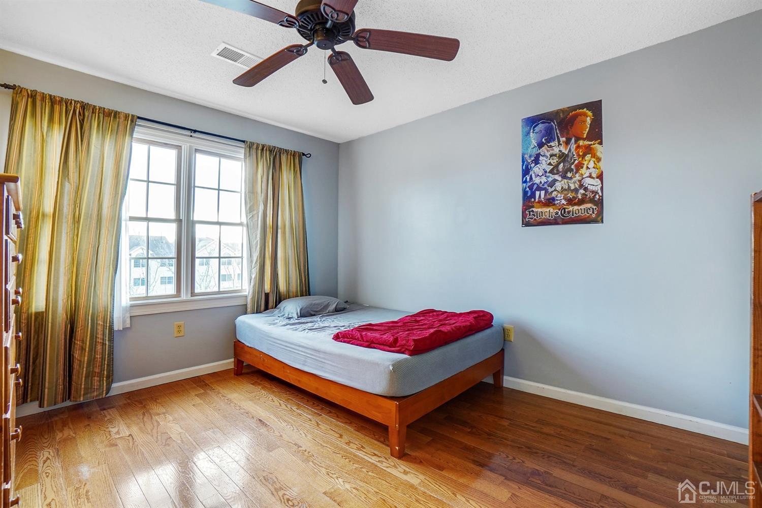 934 Edpas Road New Brunswick, NJ 08901 - Photo 10 of 16 a bedroom with a bed and a chandelier