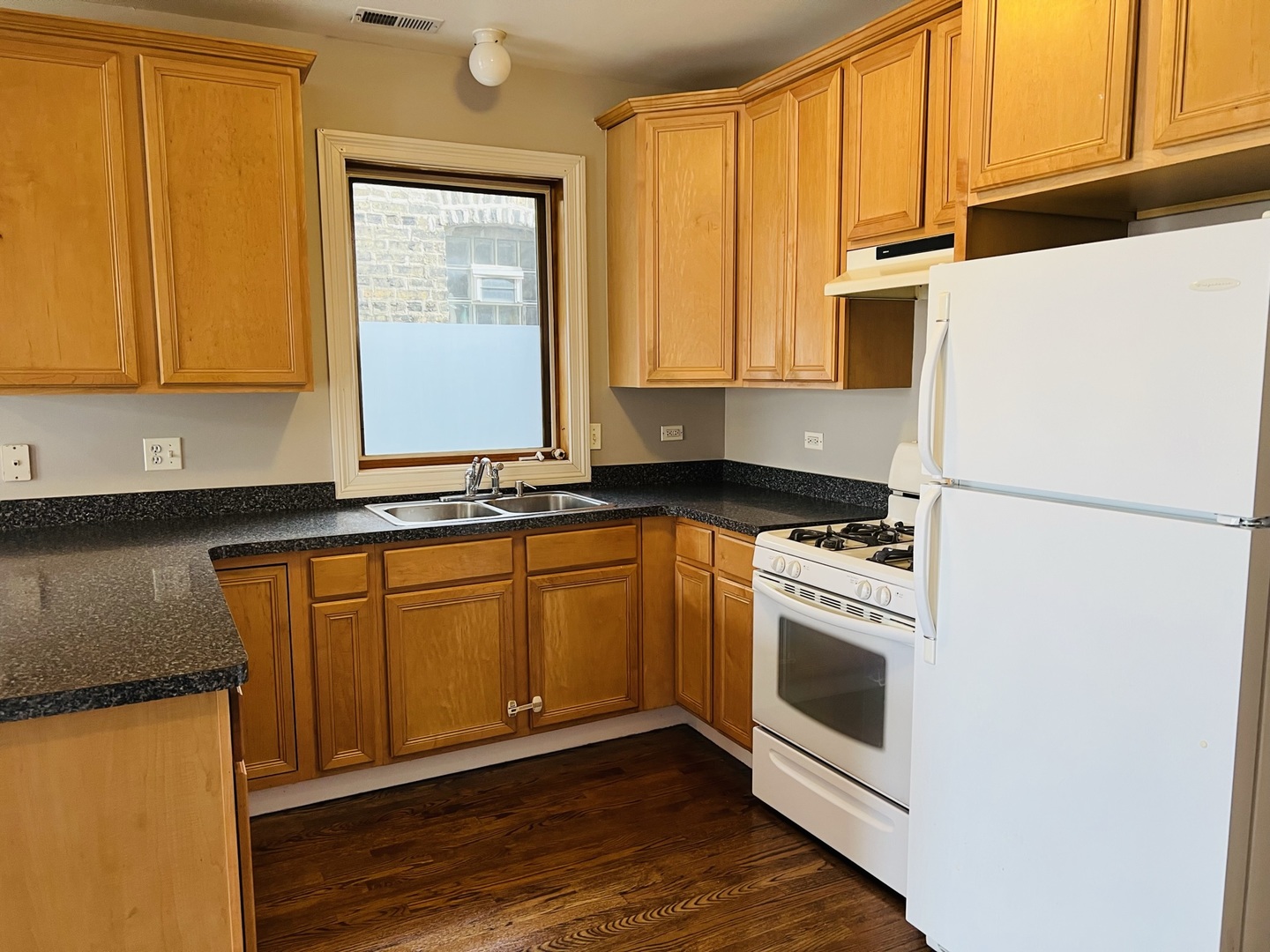 2649 West Rice Street Chicago, IL 60622 - Photo 12 of 14 a kitchen with stainless steel appliances granite countertop a refrigerator a stove a sink and a microwave