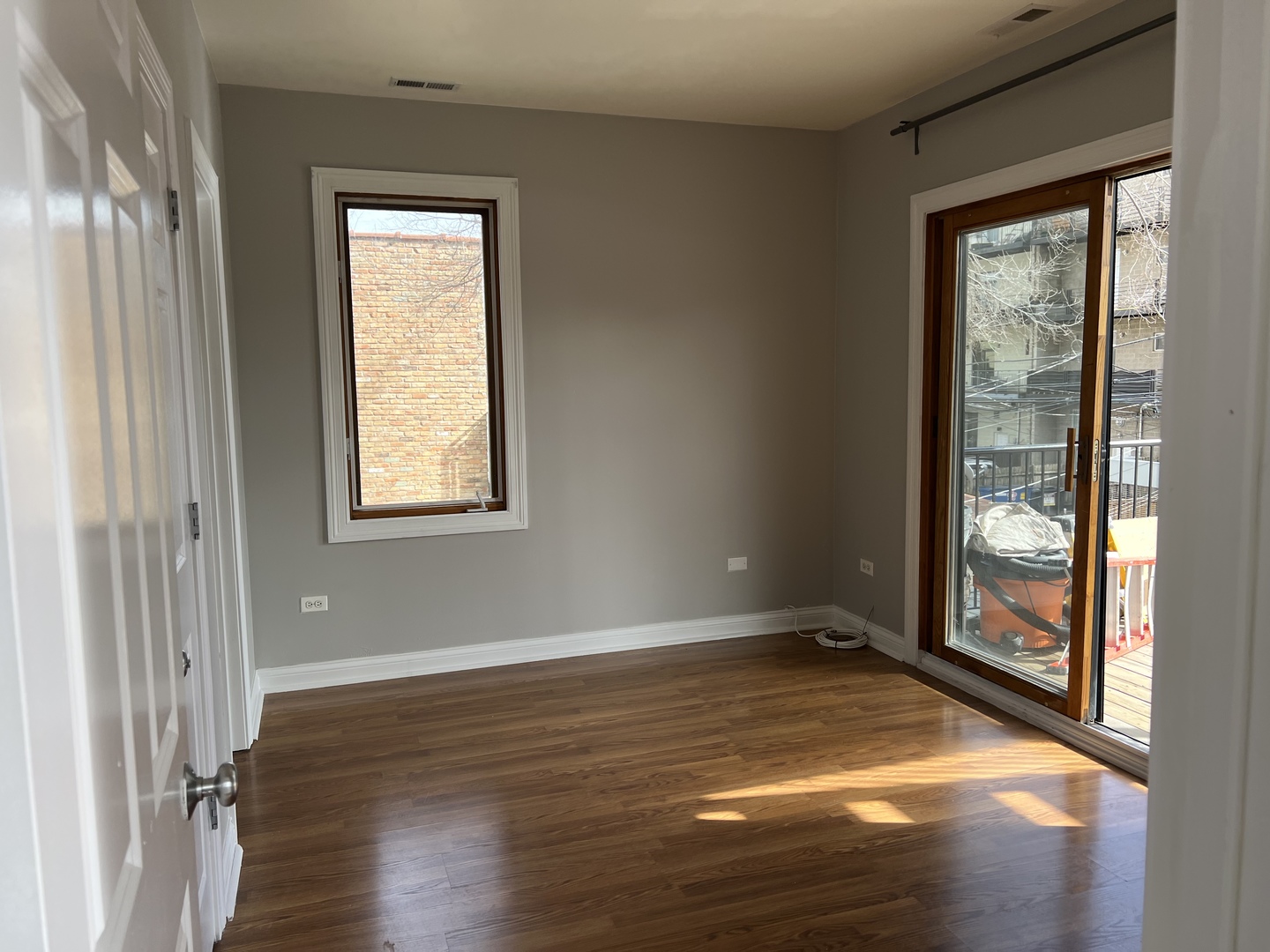 2649 West Rice Street Chicago, IL 60622 - Photo 3 of 14 an empty room with wooden floor and windows