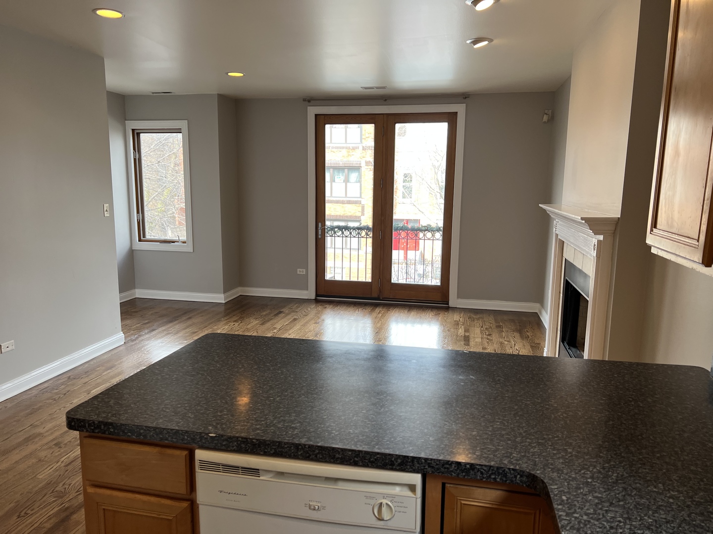 2649 West Rice Street Chicago, IL 60622 - Photo 9 of 14 an open kitchen with kitchen island granite countertop a sink a stove and a large window