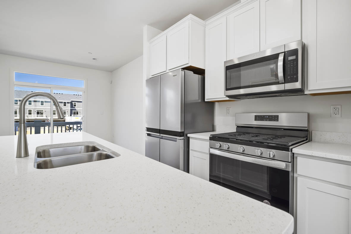 2121 Sassafras Way, Unit C Wonder Lake, IL 60097 - Photo 5 of 57 a kitchen with stainless steel appliances granite countertop a stove a microwave and a refrigerator