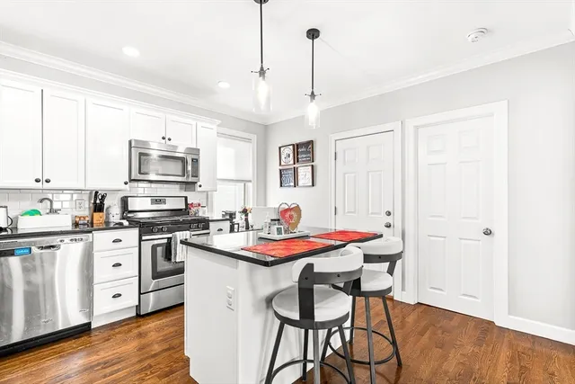 a kitchen with a stove a sink and a refrigerator