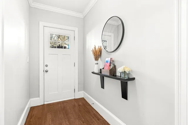 a view of a room with wooden floor and furniture
