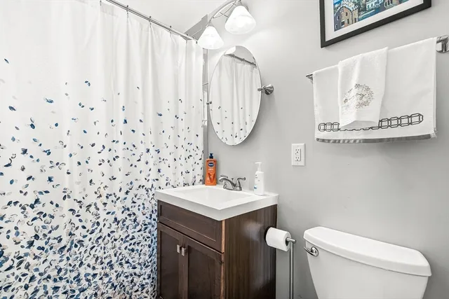 a bathroom with a sink toilet and a mirror
