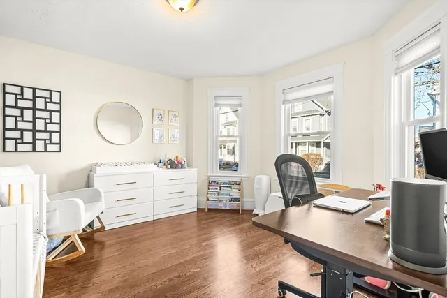 a room with a desk chair and a window